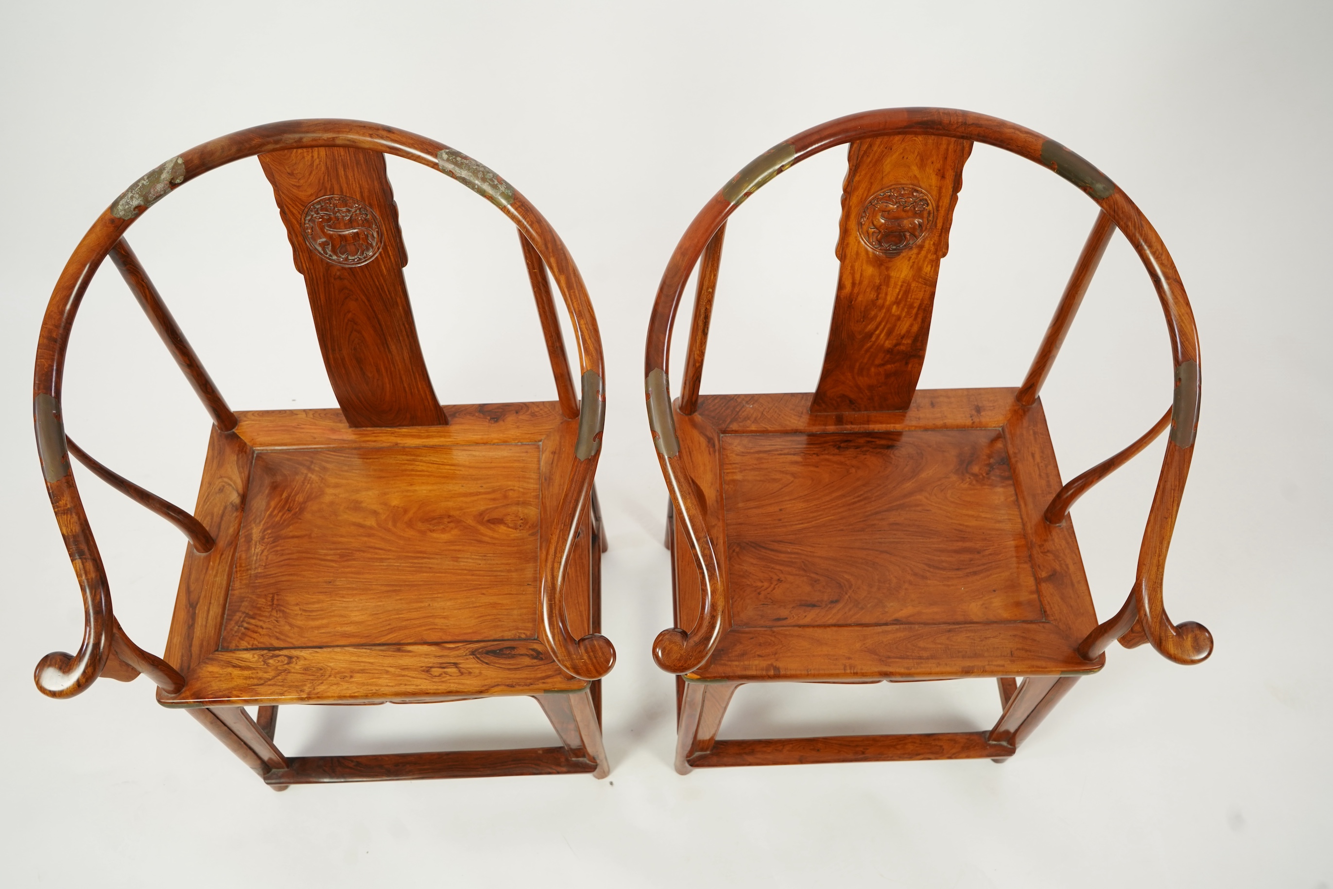 A pair of Chinese huanghuali and brass mounted horseshoe-back armchairs, quanyi, 19th century